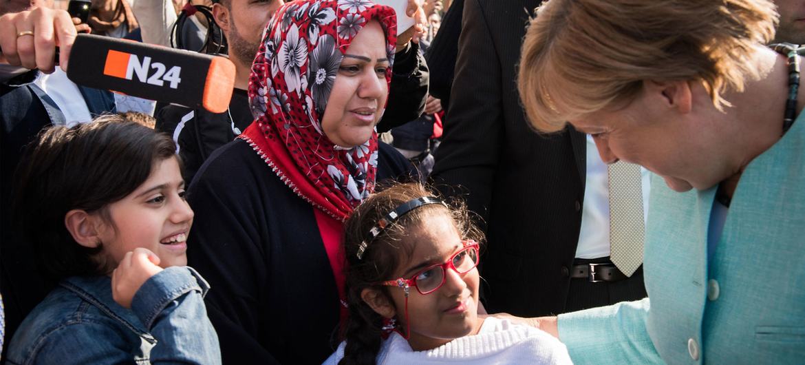 Former German Chancellor Angela Merkel interacts with refugee children in Germany.